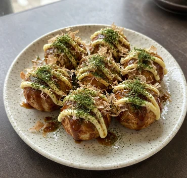 Takoyaki octopus balls with takoyaki sauce, mayo, bonito flakes and seaweed powder